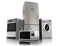 Stainless steel kitchen appliances: stove, refrigerator, microwave, and washing machine.