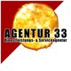 Agentur 33 Logo mit leuchtender Sonne und rotem Dreieck im Hintergrund.