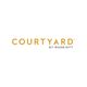 Courtyard by Marriott logo with gold lettering on a white background.