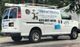 White plumbing service van with company logo and contact details on the side.