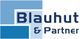 Logo von Blahut & Partner mit blauen Rechtecken und Schrift.