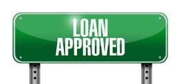 Green sign with the words "Loan Approved" in white, mounted on metal poles.