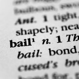 Close-up of the word "bail" with its definition in a dictionary.