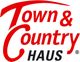 Rotes "Town & Country Haus"-Logo mit markantem Schriftzug auf weißem Hintergrund.