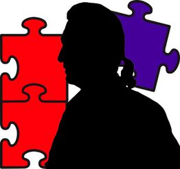 Silhouette einer Person vor roten und lila Puzzleteilen.