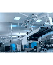 Sala operatoria moderna con luci, attrezzature mediche avanzate e tavolo chirurgico.