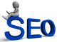 3D person sitting on large "SEO" letters with a laptop.