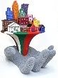 Scultura di mani che sorreggono edifici colorati su base con i colori della bandiera italiana.