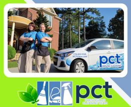 Two cleaners smiling with arms crossed in front of a house and a PCT cleaning car.