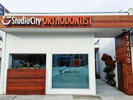 Orthodontist office with wood accents and Invisalign sign on the window.