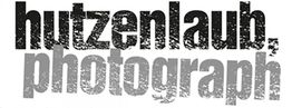 Text "hutzenlaub, photograph" in verblassenden Schwarz- und Grautönen.