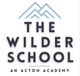 Logo of The Wilder School, An Acton Academy, with stylized mountain peaks above the text.