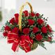 Basket of red roses with greenery and a large red bow.