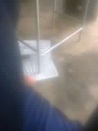 Imagem desfocada de documentos no chão sob uma estrutura metálica.