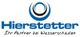 Logo: Hierstetter mit Slogan "Ihr Partner bei Wasserschäden" und blauen Kreisen darüber.