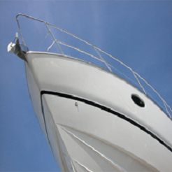Close-up of a boat's bow against a clear blue sky.