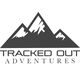Logo of "Tracked Out Adventures" featuring stylized mountain peaks above the text.