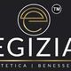 Logo nero con testo "Egizia Estetica Benessere" e simbolo dorato.