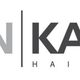 Logo van Jansen Kappers met de tekst "Hair Designers" in grijze en zwarte letters.