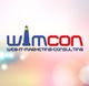 WIMCON-Logo mit Leuchtturmsymbol und Text "Web-IT-Marketing-Consulting" auf unscharfem Hintergrund.