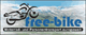 Logo mit Motorrad, Text: „free-bike - Motorrad- und Personentransport europaweit“, im Hintergrund Berge.