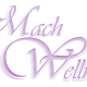Schriftzug "Mach Wellness" in lila, geschwungener Schrift auf weißem Hintergrund.