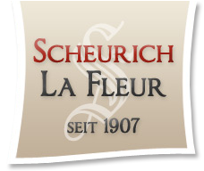 Logo mit Text: Scheurich La Fleur seit 1907, beige Hintergrund, geschwungenes S im Hintergrund.