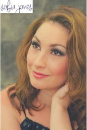 Smiling woman with light brown hair gazes up thoughtfully, hand on chin. Signature reads "sofia jones".