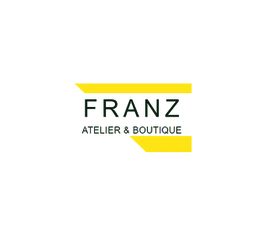 Logo von "Franz Atelier & Boutique" mit gelben Akzenten auf weißem Hintergrund.