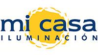 Logo de "mi casa ILUMINACIÓN" con un sol amarillo detrás del texto.