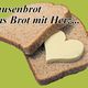 Zwei Brotscheiben mit herzförmiger Butter. Text: "Pausenbrot, Das Brot mit Herz...".