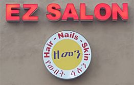 Sign for "EZ SALON" with "Hair - Nails - Skin" in English and Amharic below.