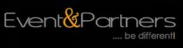 Schwarzes Logo: "Event & Partners" in Grau und Orange, Slogan: "... be different!" in Weiß.