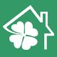 Symbol eines Hauses mit einem vierblättrigen Kleeblatt auf grünem Hintergrund.