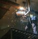 Person welding pipes with sparks flying in an industrial setting.