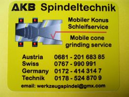 Gelbes Werbeschild von AKB Spindeltechnik mit Kontaktinfos und Serviceangebot für Konusschleifen.