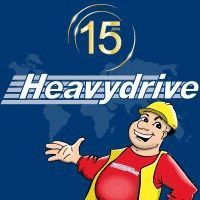 Zeichentrickfigur mit Bauhelm, daneben "Heavydrive"-Logo und "15 Jahre" auf blauem Hintergrund.