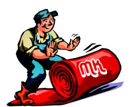 Mann in Arbeitskleidung rollt roten Teppich mit "mk"-Logo aus.