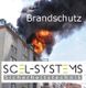 Brennendes Gebäude mit schwarzem Rauch, Text „Brandschutz“, Logo „SCEL-SYSTEMS Sicherheitstechnik“.