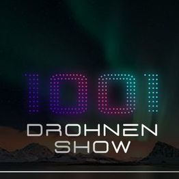 Text: "1001 DROHNEN SHOW" vor einem dunklen Himmel.