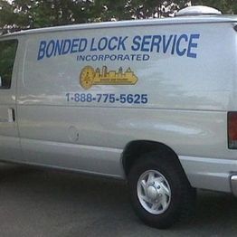 White van with "Bonded Lock Service" and a phone number on the side.