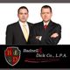 Two men in suits pose with arms crossed next to a law firm logo for disability and injury attorneys.
