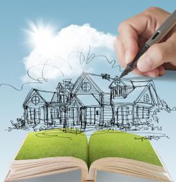 Hand drawing a house over an open book with grassy pages under a sunny sky.
