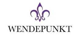 Wort "Wendepunkt" mit einer lila Lilie darüber.