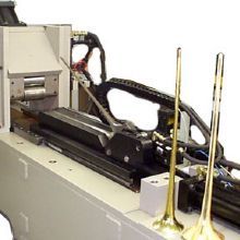 Machine part with metal rods; appears to be industrial equipment for manufacturing.