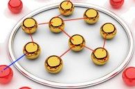 Goldene Kugeln sind durch rote Linien auf einem ovalen Tablett miteinander verbunden.