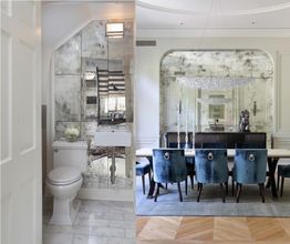 Luxurious bathroom and dining room with mirrored walls and elegant blue chairs.