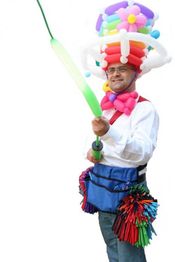Mann mit Ballonhut und Ballonschwert, trägt bunte Ballons an einer Gürteltasche.
