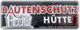 Schild mit Text "Bautenschutz Hütte" und Zeichnung eines Hauses.