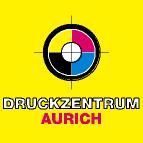 Gelber Hintergrund, Zielscheibe in CMYK-Farben, Text "DRUCKZENTRUM AURICH" darunter.